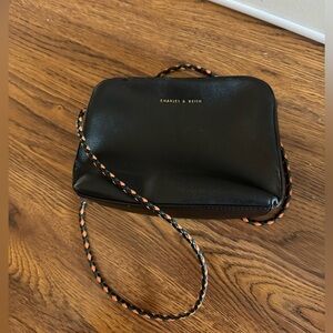 Charles and Keith black crossbody purse it’s colourful braided strap